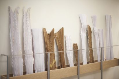 A shelf stores pleating moulds at Ginlee Studio store