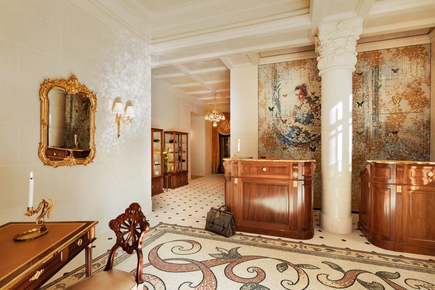 Reception area with mosaic flooring and mural