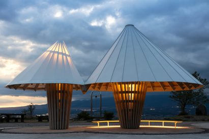 The Oath Hill Park structures are illuminated from within by warm lighting