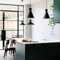 Kitchen with dark green cabinets