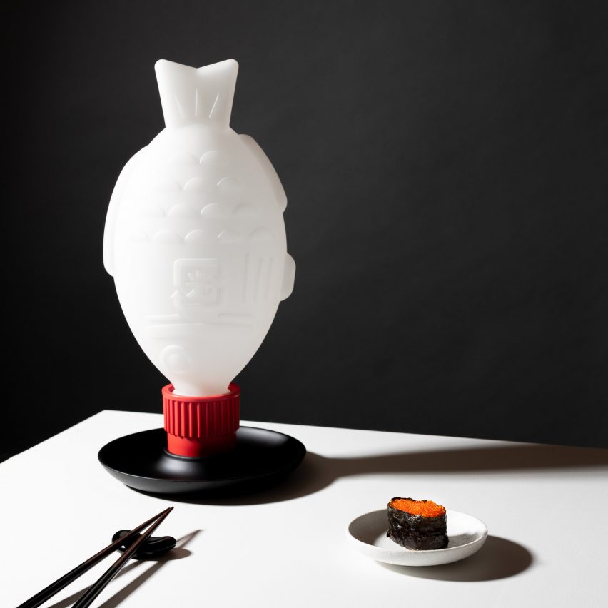 A photograph of Light Soy lighting by Heliograf, which looks like a fish-shaped soy sauce packet