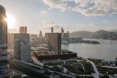 M+ museum by Herzog and de Meuron, viewed in profile showing two volumes intersecting in an inverted T shape