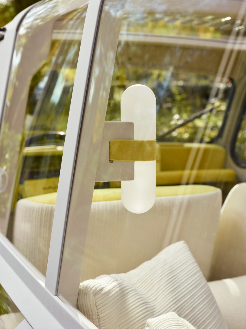 View through the rear windows of the Suite No.4 Renault concept car showing cream-coloured cushions and a capsule-shaped wall light