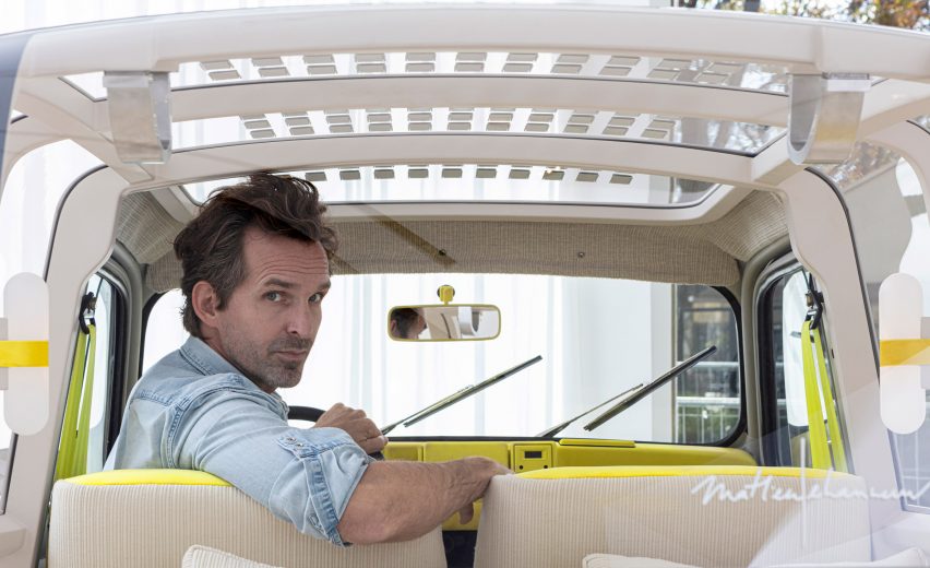Mathieu Lehanneur in the driver's seat of his Suite No.4 Renault car peers back over his shoulder, while transparent solar panels can be seen on the transparent roof above