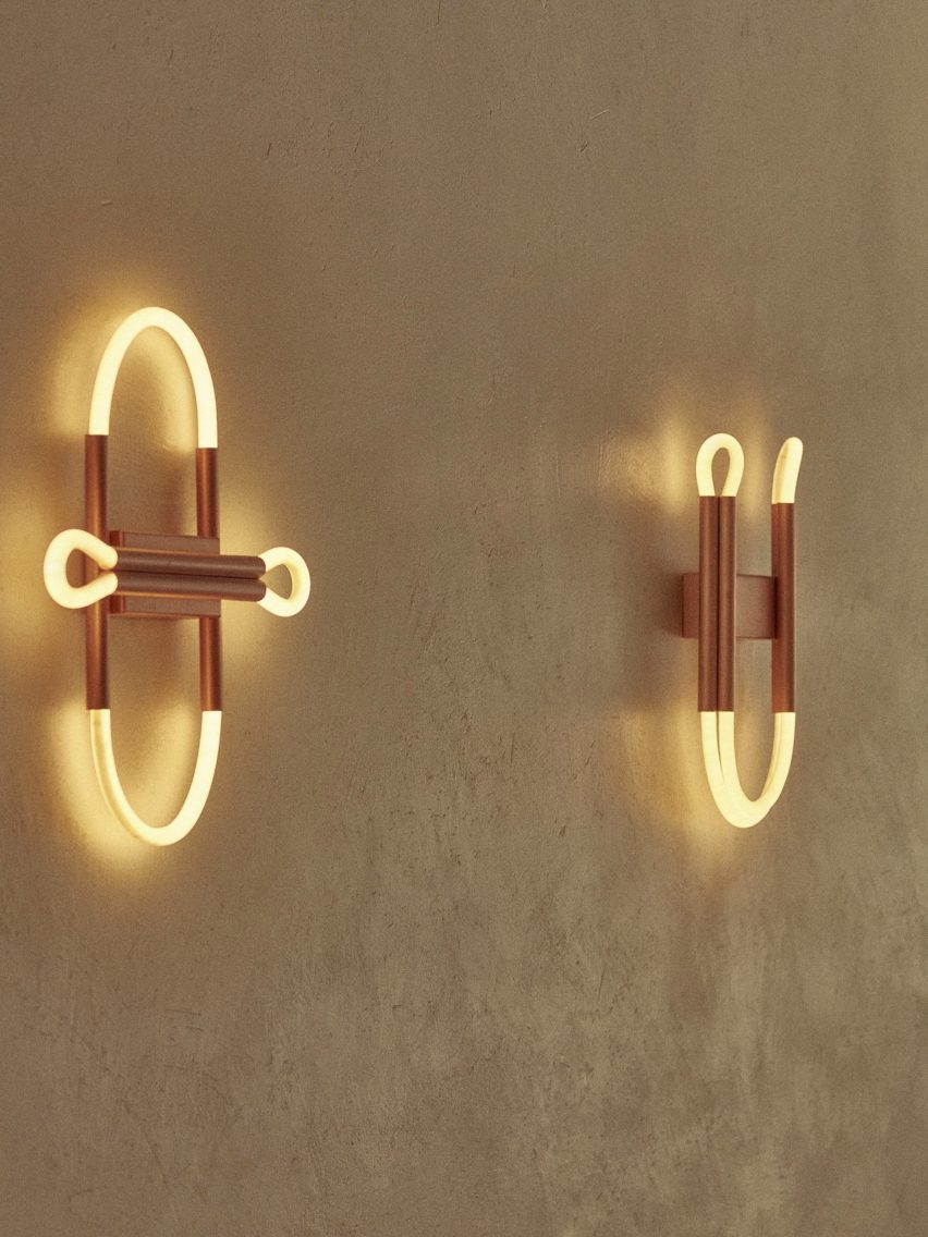 Copper and tube lighting fixtures in sculptural shapes on a wall