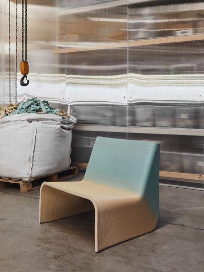 Gradient blue and yellow Ermis chair in an industrial warehouse