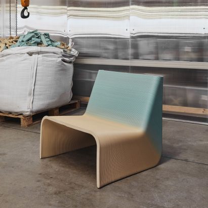 Gradient blue and yellow Ermis chair by The New Raw in an industrial warehouse