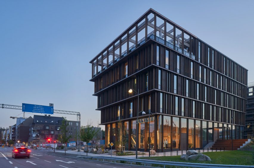 Night view of Nodi wooden office building by White Arkitekter