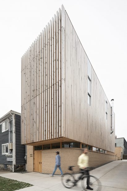 Cedar-clad box atop a brick ground floor