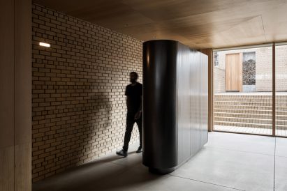 Pill-shaped steel closet in the entryway