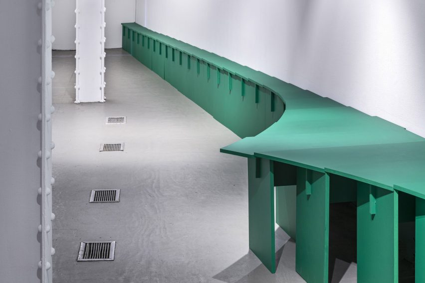 A curving series of green tables