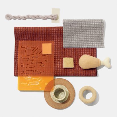 Swatches of Kvadrat's Sabi textile upholstery in a deep orange colour with similarly coloured objects