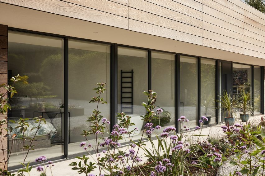 Glazed facade of Facade of Sayang House by Carlos Gris