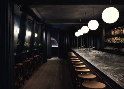 The interior of SOMA Soho has a dark and moody look