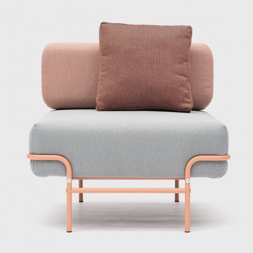 A photograph of a Tangens office furniture chair with pink steel legs and grey and pink seat cushions