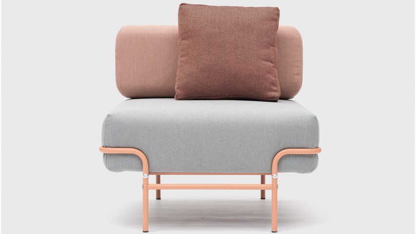 A photograph of a Tangens chair with pink steel legs and grey and pink seat cushions