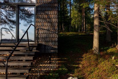 A cabin covered in black shingles