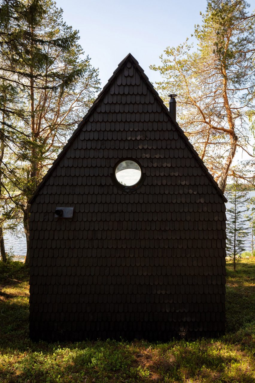 Cabin clad with black shingles