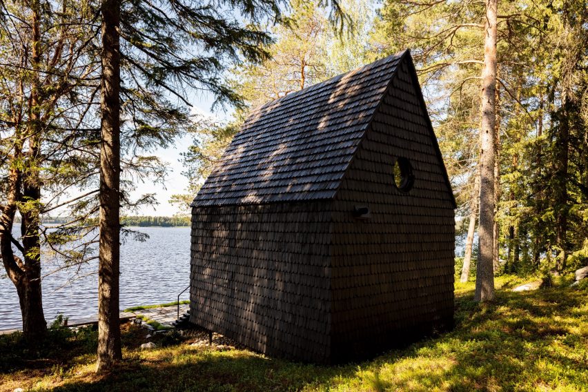 Cabin clad with black shingles