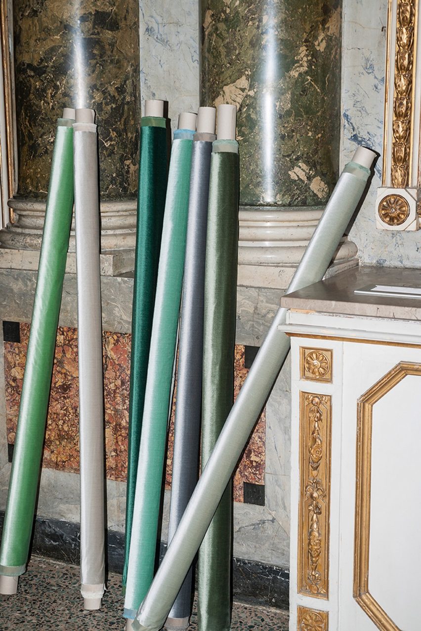 Dedar's Romeo & Giulietta fabrics in varying shades of green rolled up against a wall