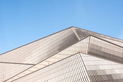 A photograph of Shanghai Jiuguang Center's facade, which is made up of ceramic white tiles 