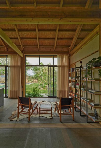 Seating area with cow hide rug and book shelves