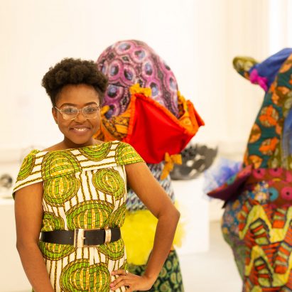 A photograph of a Art and Design student dressed in a colourful print dress