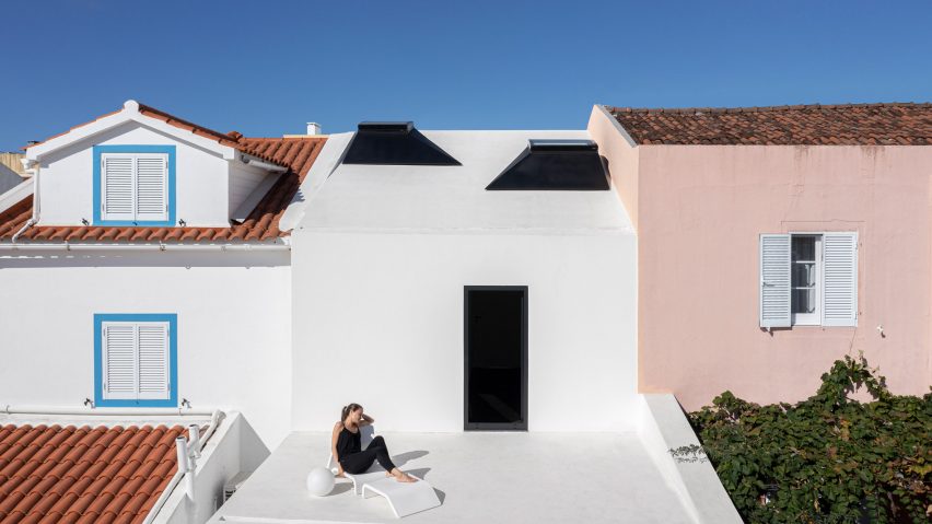 A person is sat on the terrace of Windmill House