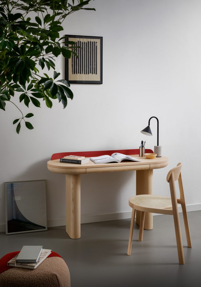 A photograph of a Brulla chair in natural ash situated at a desk
