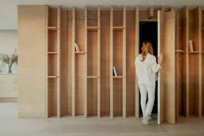 Joinery with hidden door in City Approach apartments by DROO