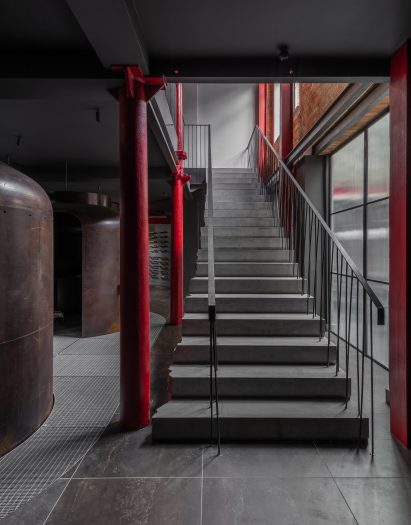 Limestone staircase framed by red columns leading to basement of Boiler on ground floor of Coalbrook's showroom