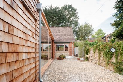 Image of the cedar extension and original stone building at Woodthorp Stables