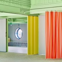 Coloured details including red curtain and yellow screen, Educan school for dogs, humans and other species