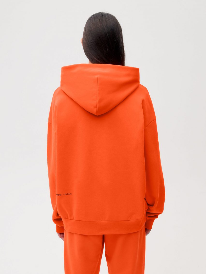 A model wearing Es Devlin's orange clothing for Pangaia
