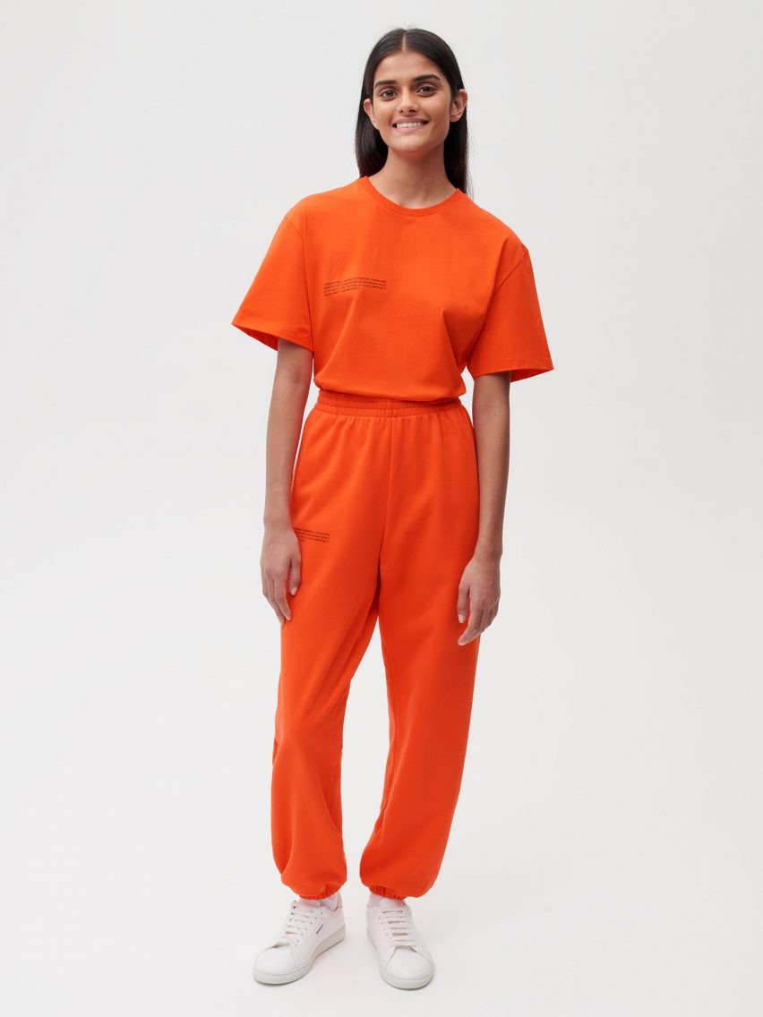 A model wearing Es Devlin's orange clothing for Pangaia