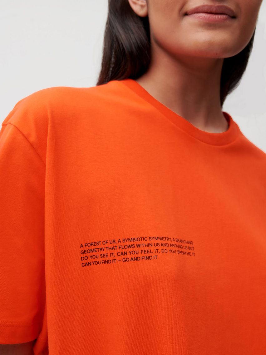 A model wearing Es Devlin's orange clothing for Pangaia