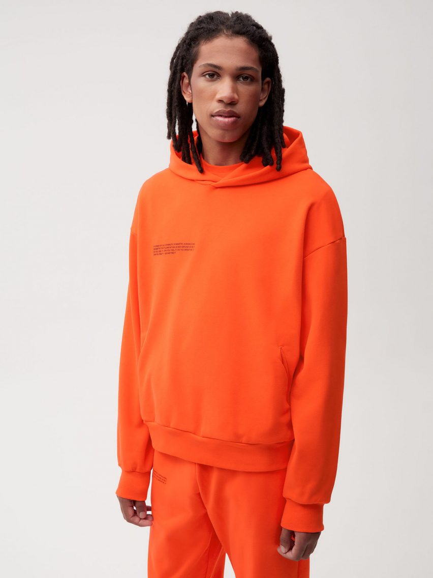 A model wearing Es Devlin's orange clothing for Pangaia