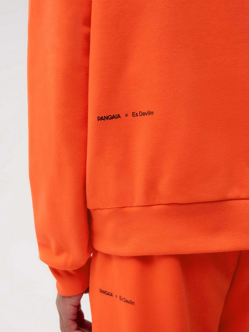 A model wearing Es Devlin's orange clothing for Pangaia