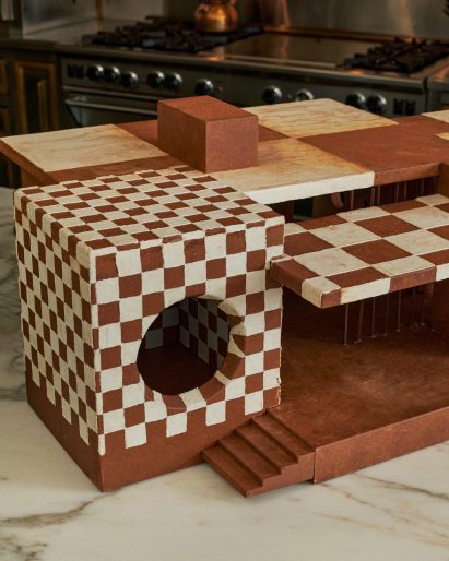 Gingerbread house in modernist style with checkerboard icing and large porthole window