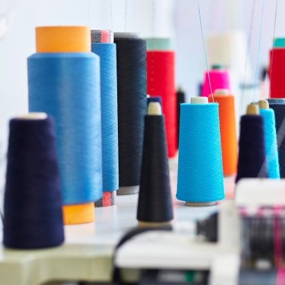 A photograph of a range of colourful sewing threads