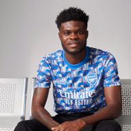 A model wearing a patterned Arsenal shirt