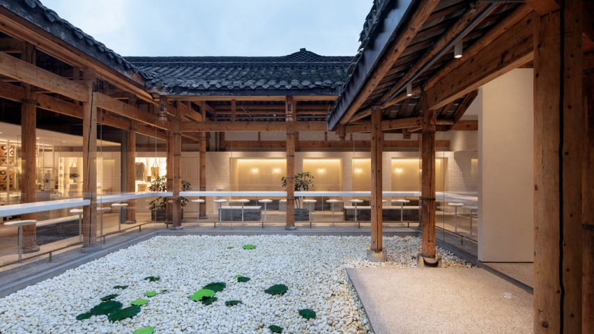 Central coutryard of % Arabica coffee shop in Kuanzhai Alley filled with water and white pebbles