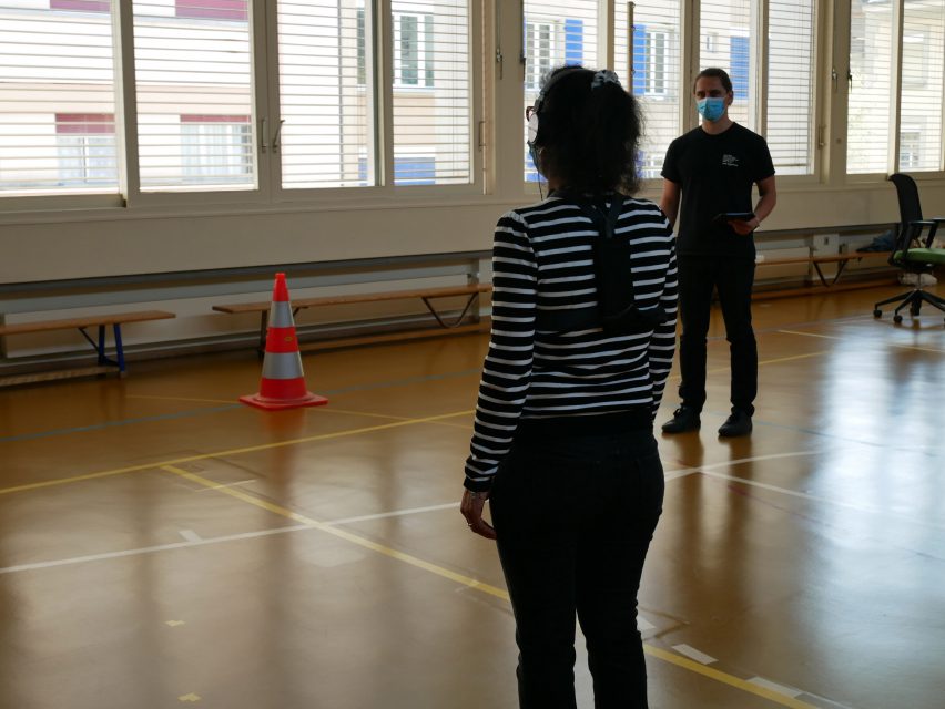 A woman tests Biped.ai in a gym