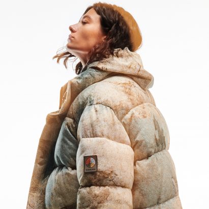 Model wearing beige puffer coat by Christopher Raeburn