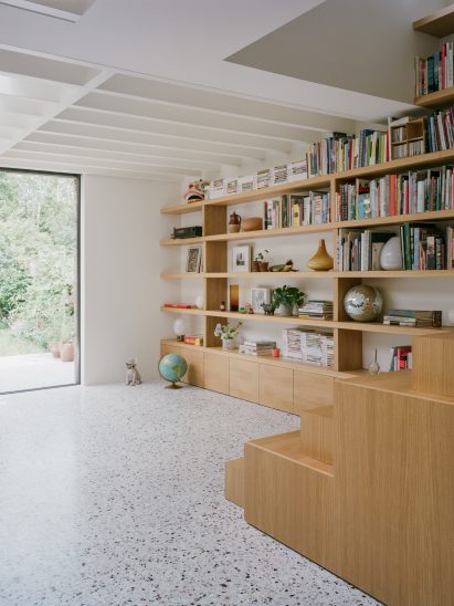 Staircase and bookshelves in Farleigh Road renovation and extension by Paolo Cossu Architects
