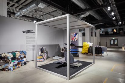 Fibers Unsorted installation at Dutch Design Week 2021, with an automotive-themed abstract display hanging within a cubic frame