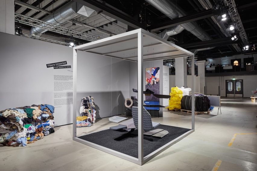 Fibers Unsorted installation at Dutch Design Week 2021, with an automotive-themed abstract display hanging within a cubic frame