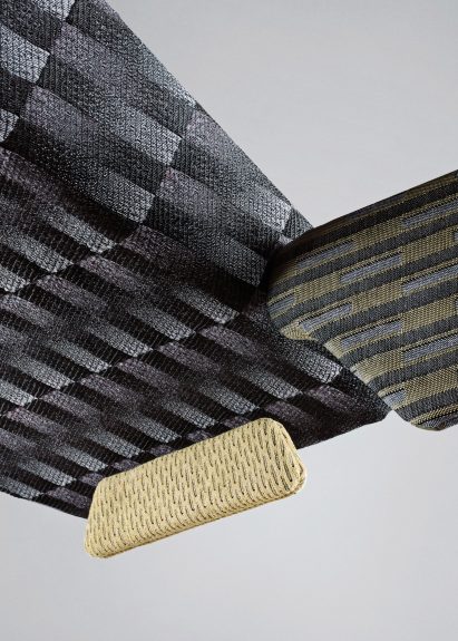 Various Fibers Unsorted textiles in shades of grey and yellow upholstered over abstract shapes