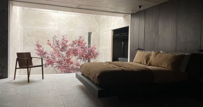 A dark bedroom with a full length window
