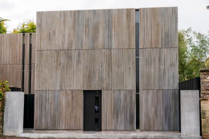 The slatted timber facade of the house on the set of The Girl Before